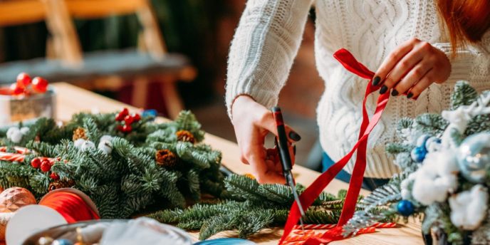 woman prepares holiday decorations