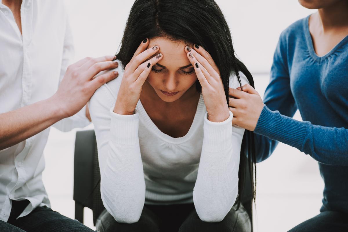 therapy group meets to discuss addiction triggers