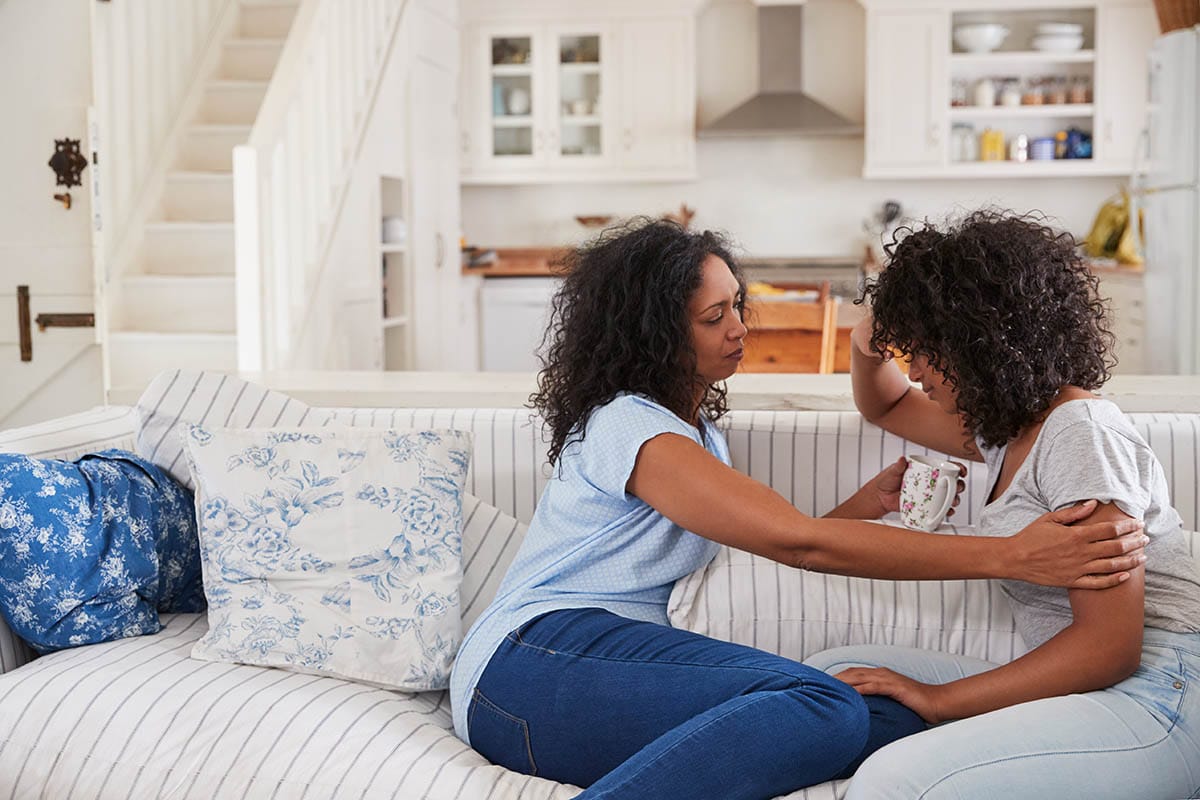 two women sitting on couch